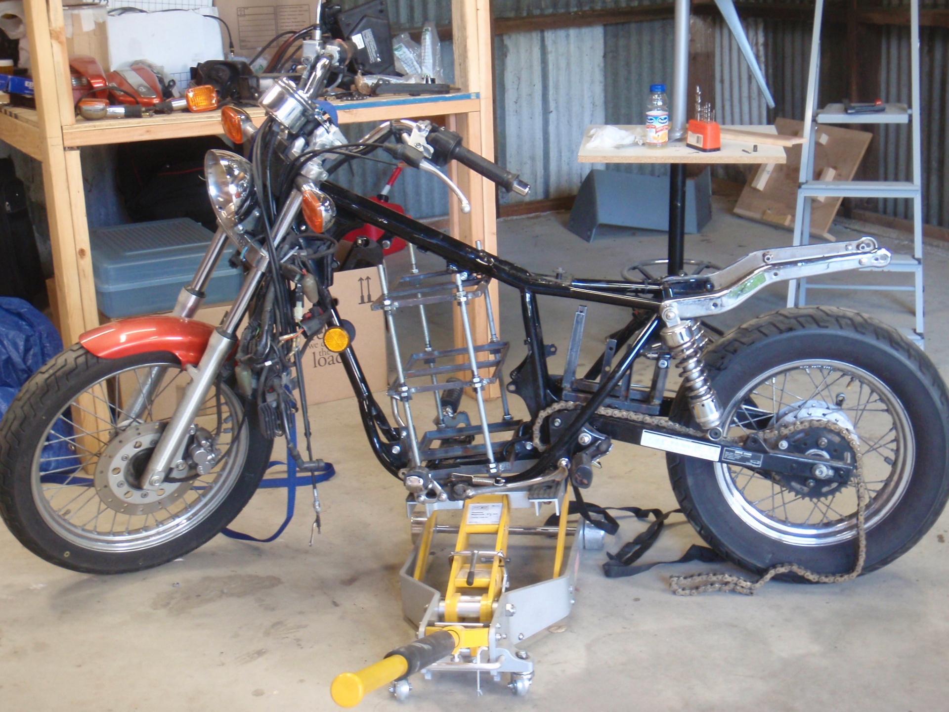 Honda Rebel 250 stripped to the frame in the shop, mid-conversion to electric drive