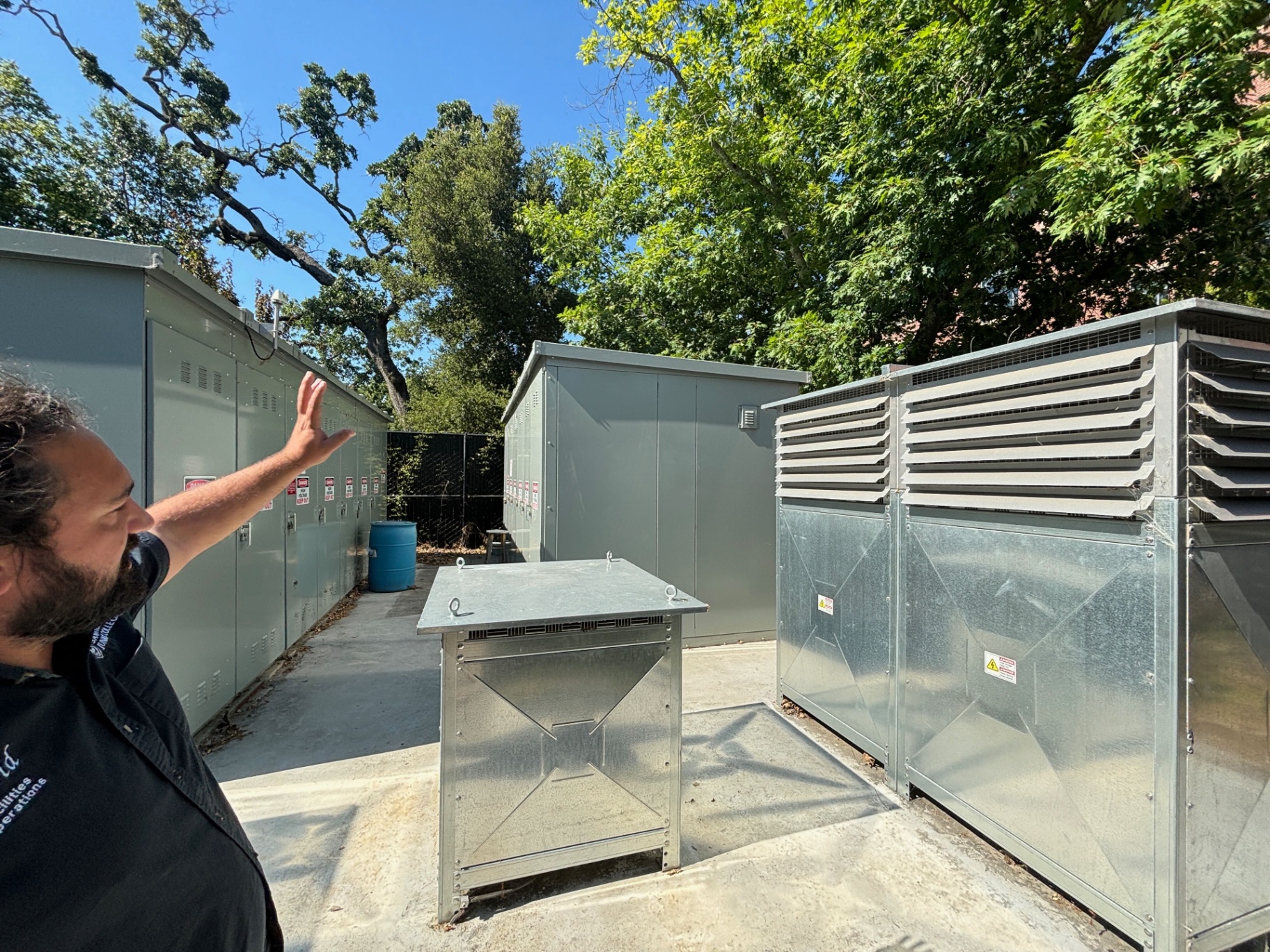 SRJC facilities staff at the campus microgrid battery and inverter enclosures