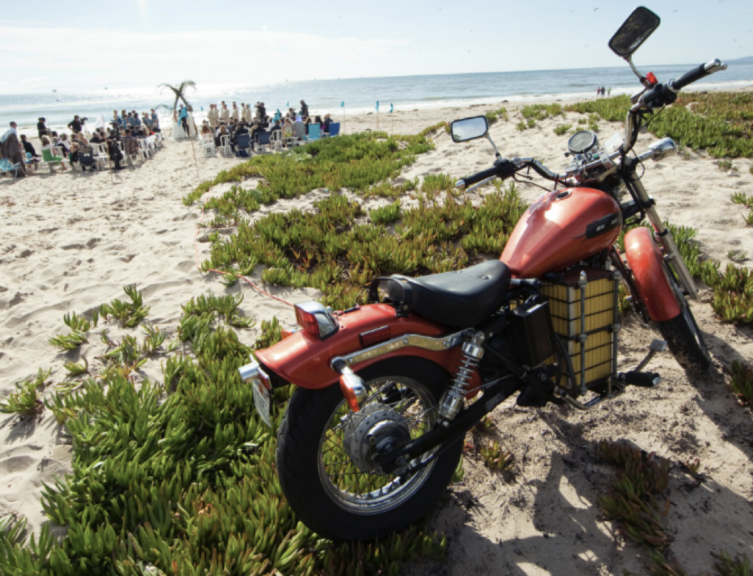 The electric Honda Rebel parked in beach ice plant during Tim and Meredith's wedding ceremony in Carpinteria